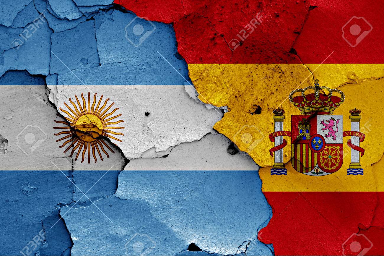 flags of Argentina and Spain painted on cracked wall